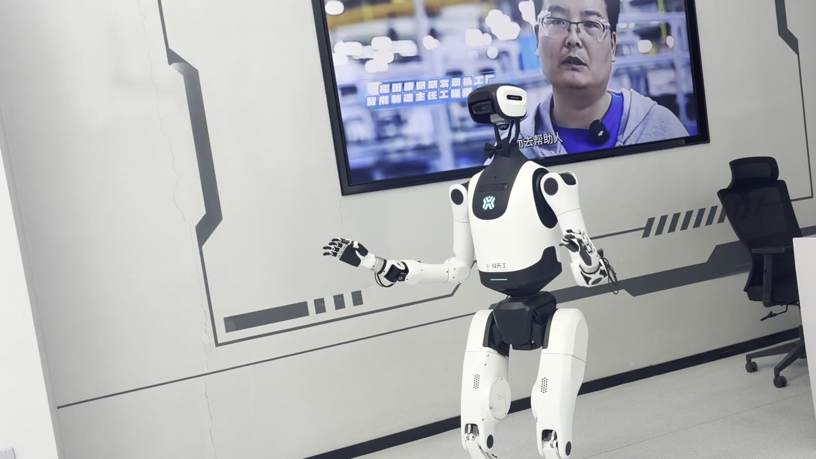 A robotic arm cooking pancakes on a griddle inside a Beijing restaurant